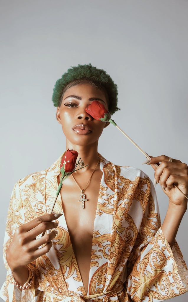 Stylish portrait of a woman holding red roses, showcasing glamour and elegance.