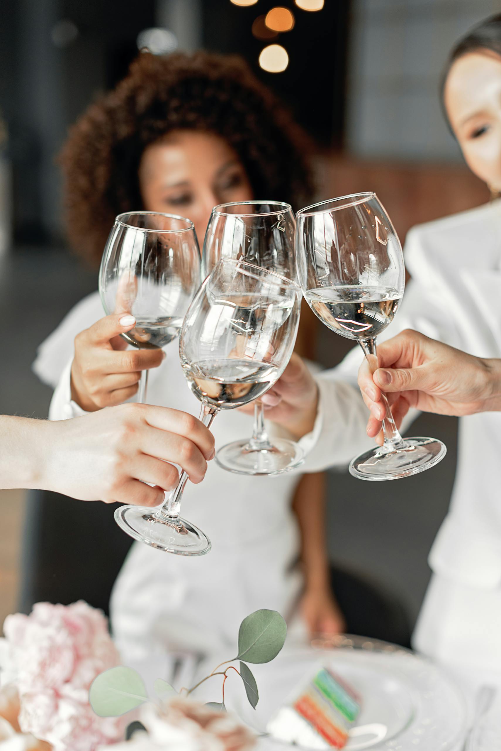 Friends celebrating together toasting with wine glasses, symbolizing joy and unity.